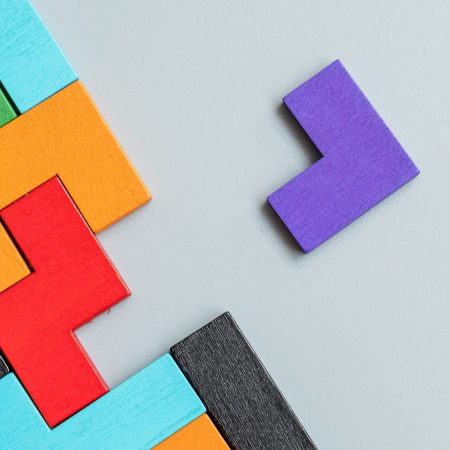 geometric shape block with colorful wood puzzle piece background. logical thinking, business logic, Conundrum, decision, solutions, rational, mission, success, goals and strategy concepts